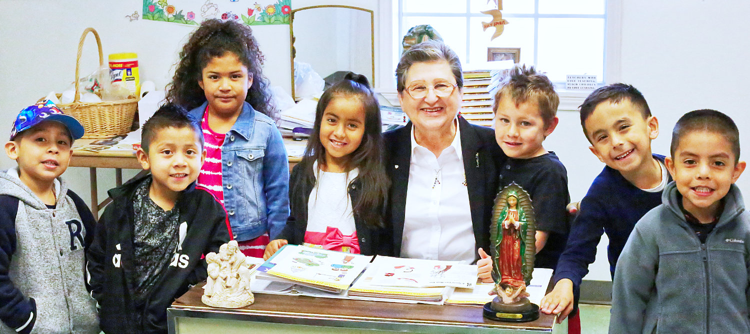 Elizabeth Wiese of St. Peter’s Catholic Church shown with her present class of kindergartners. She has been teaching Sunday school there for 45 years and plans to retire this year.
